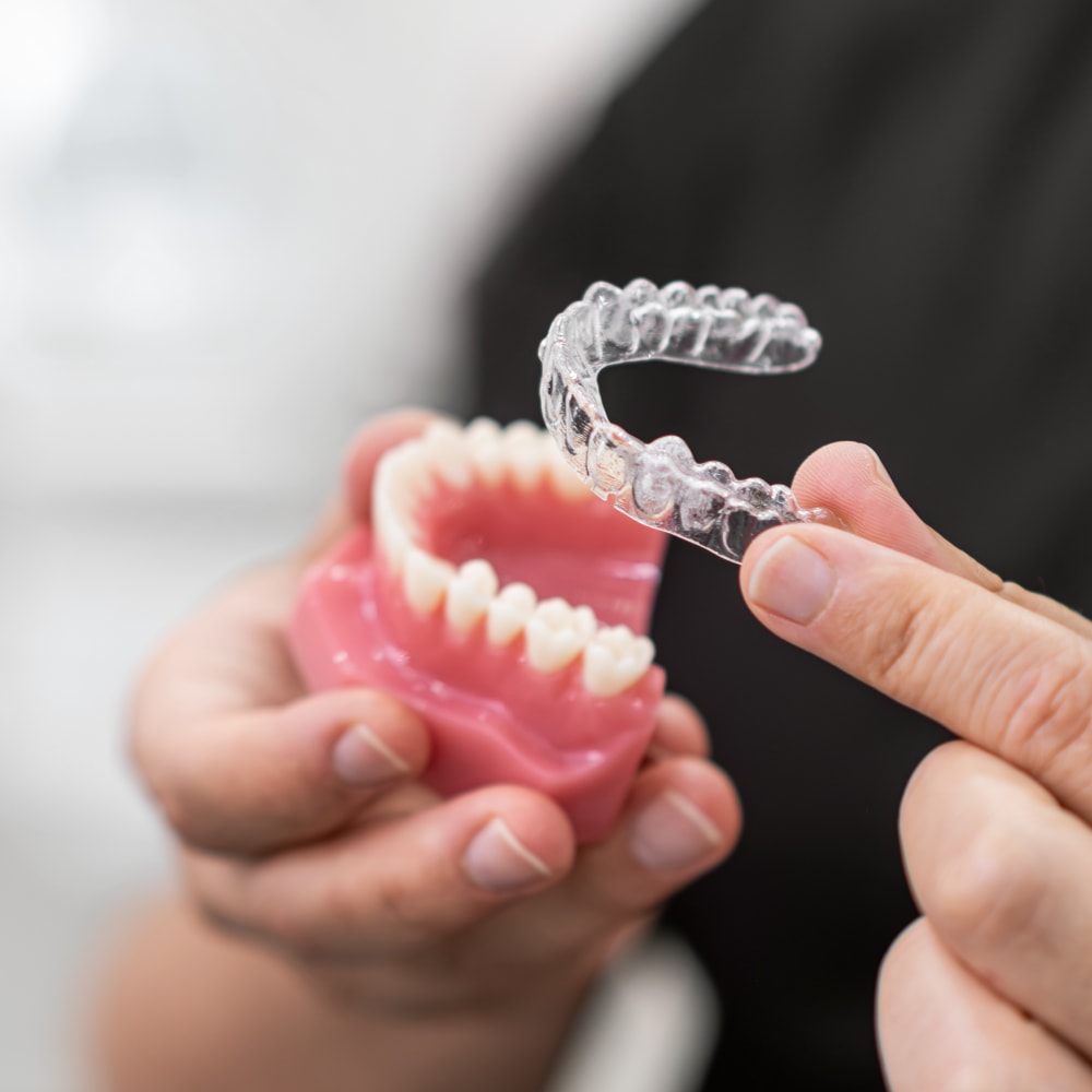 doctor holding Invisalign adults model prepared for patient