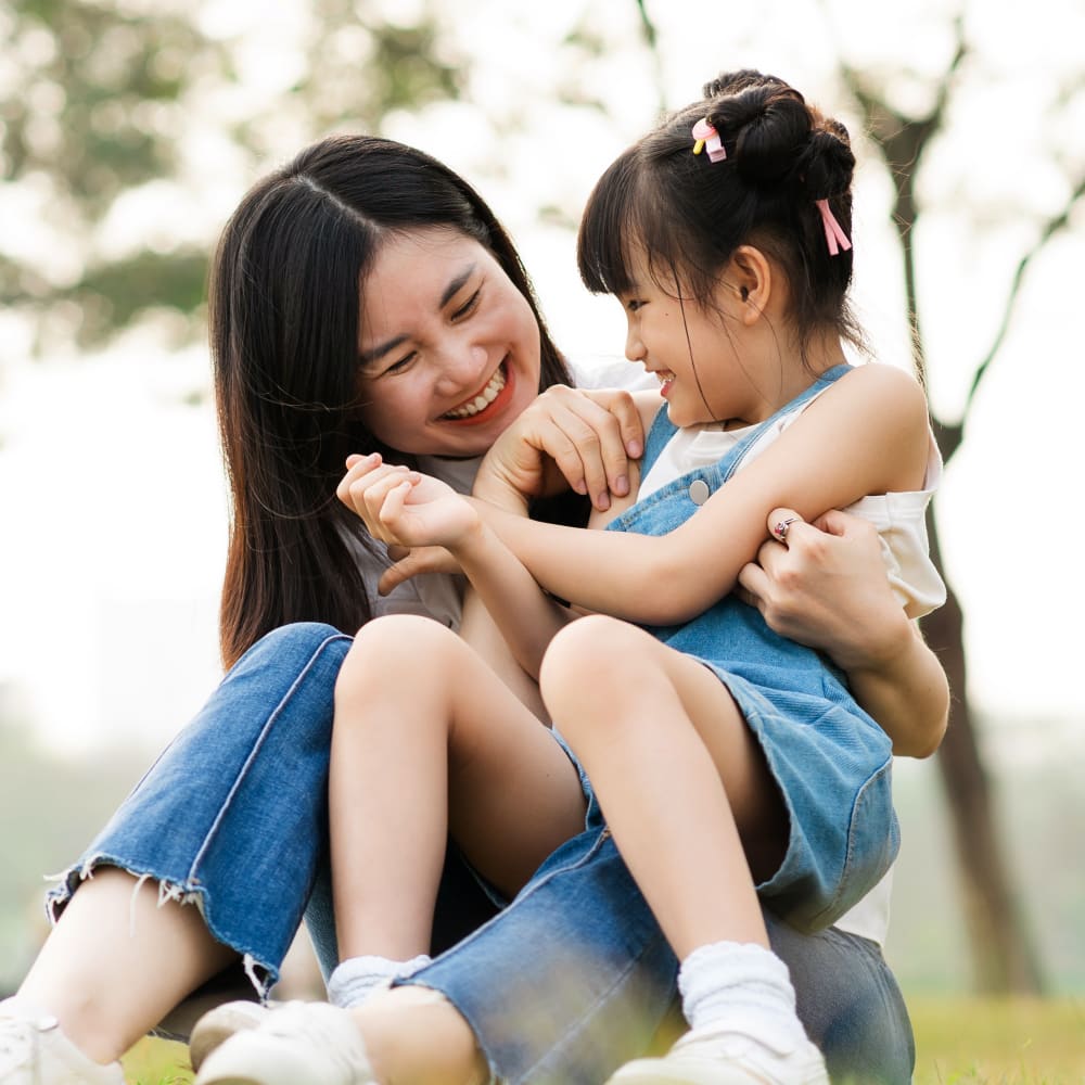 mother and young daughter are hugging after daughter had early orthodontic treatment