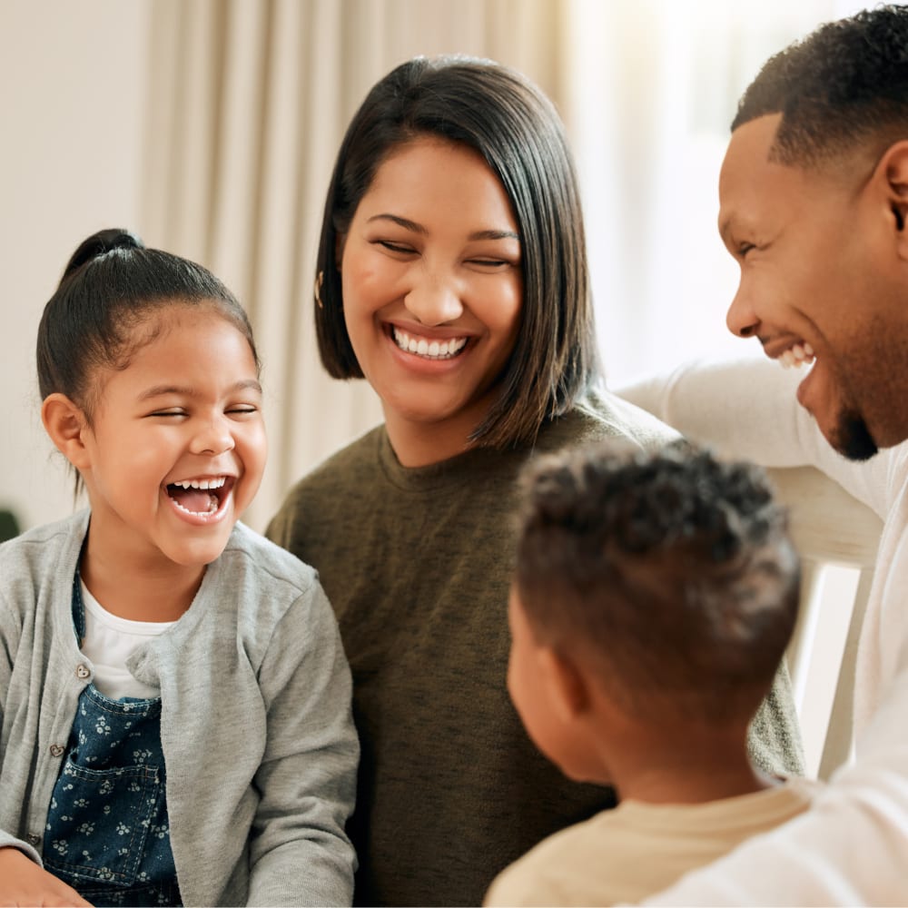 Happy family smiling together after winning Smile Reward at Village Orthodontics