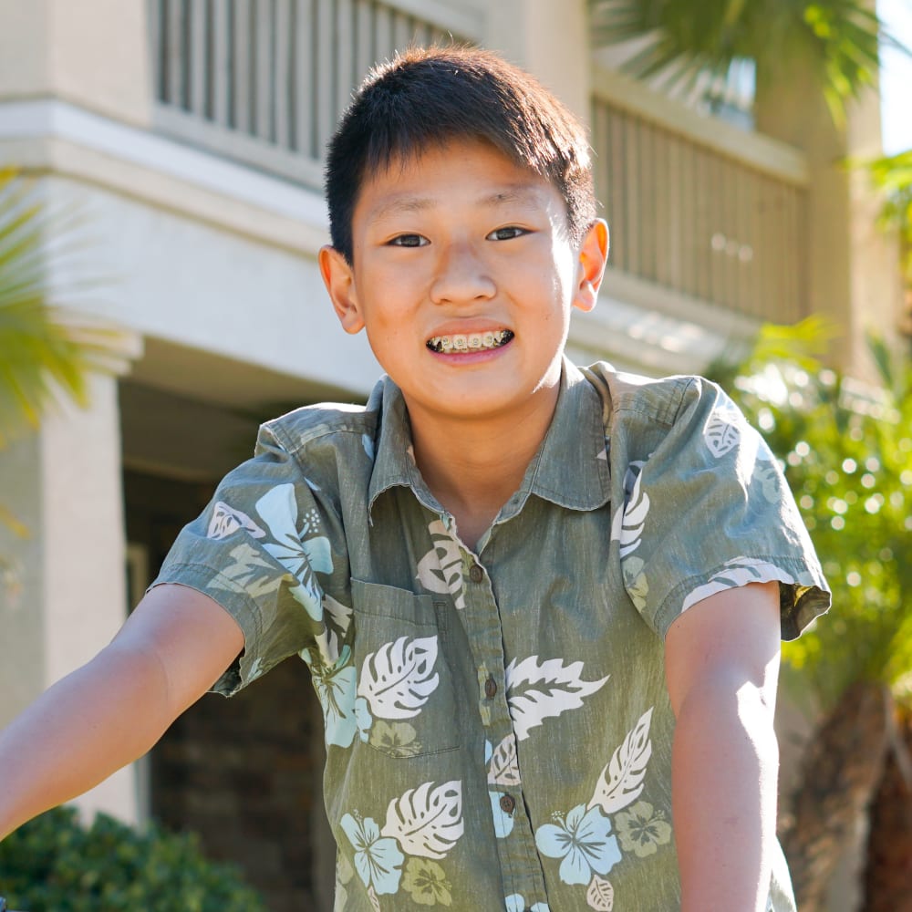 Teen boy smiling and having braces for teens on his teeth