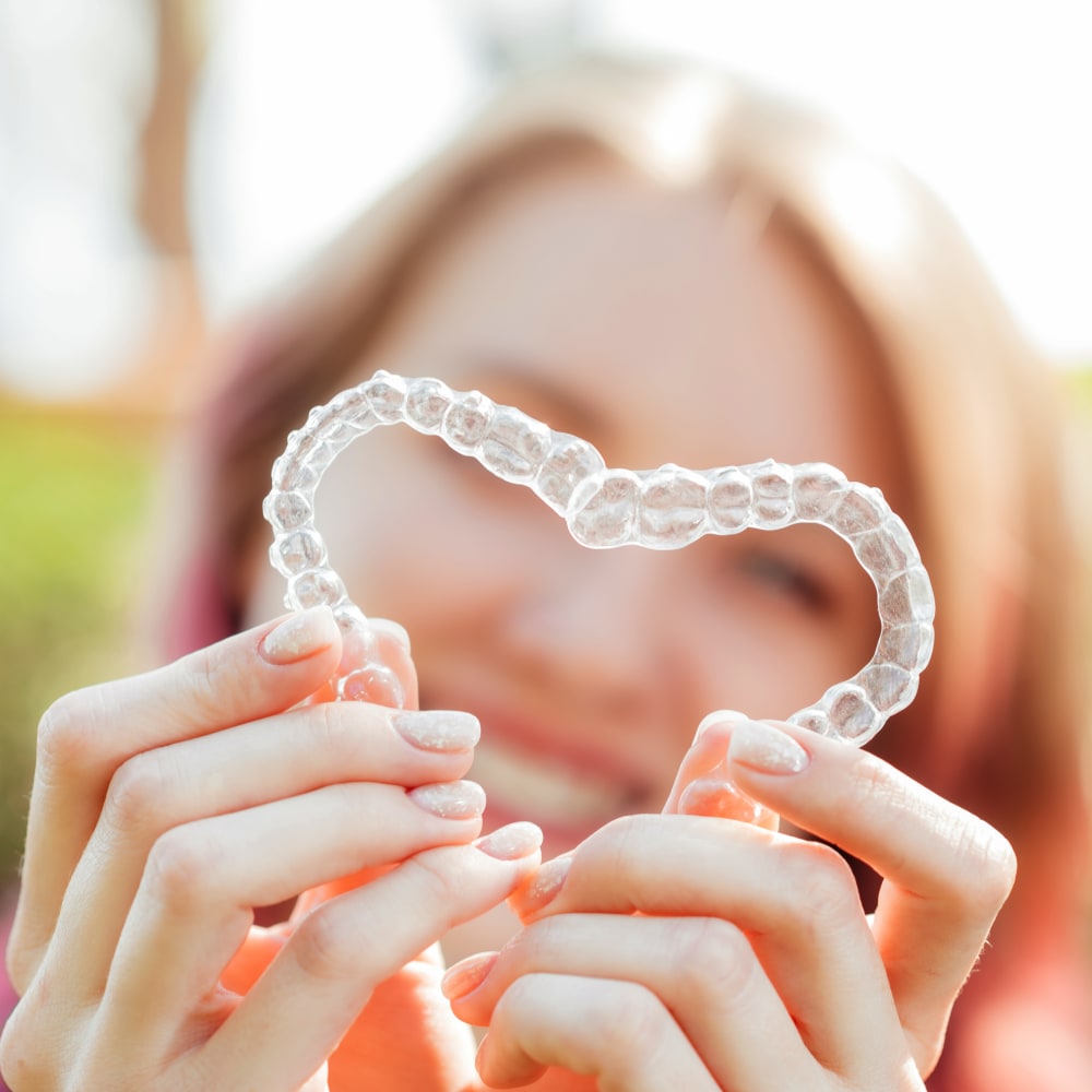 teen girls holding Invisalign for Teens