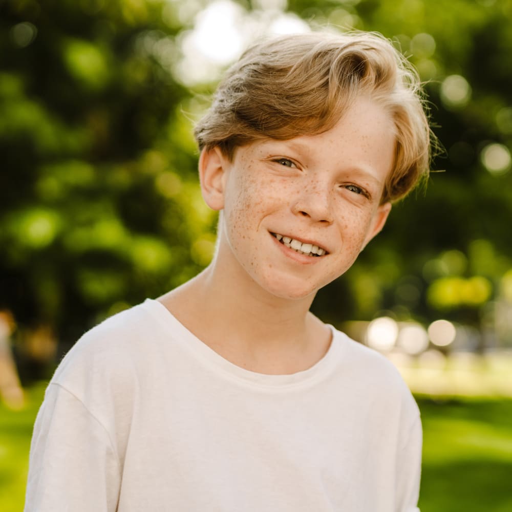 happy boy smiling after getting Treatment for Sleep Apnea & Airway Issues in Teens