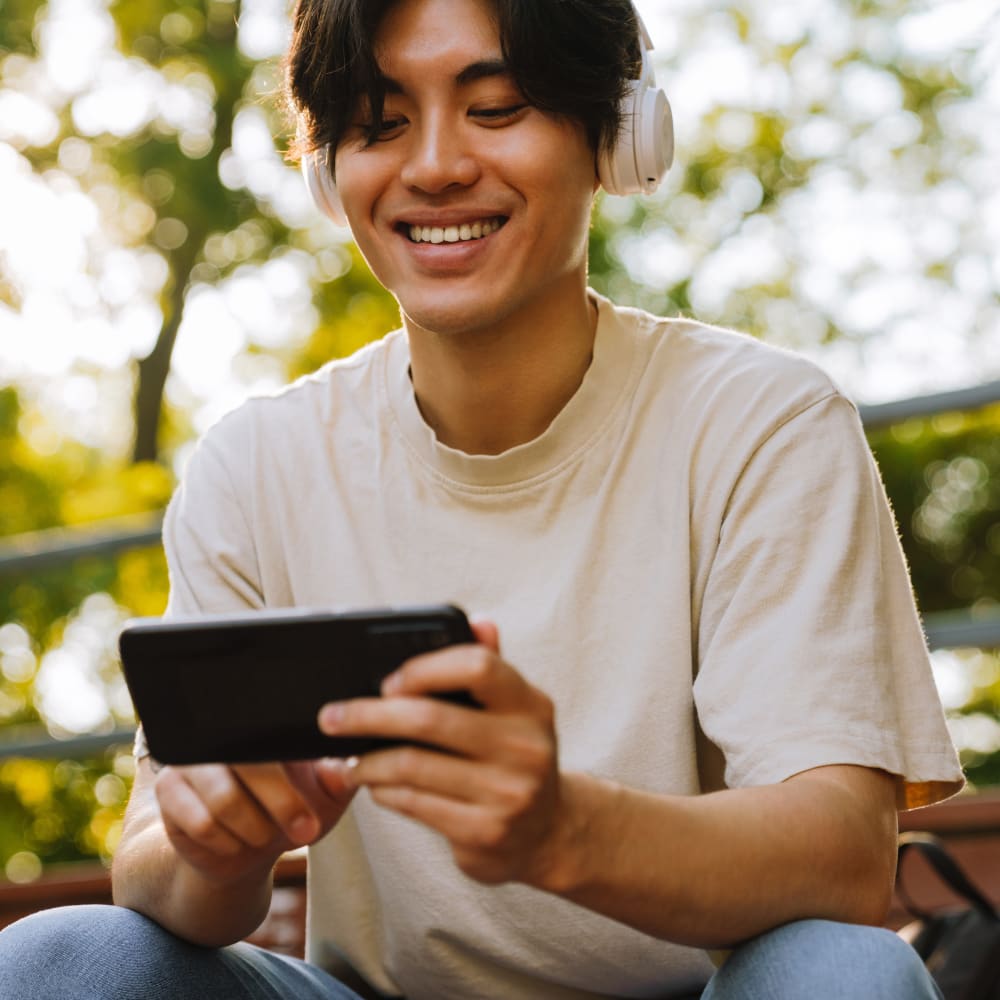 teenager laugh and listens to music after his visit to Village Ortho orthodontic specialists